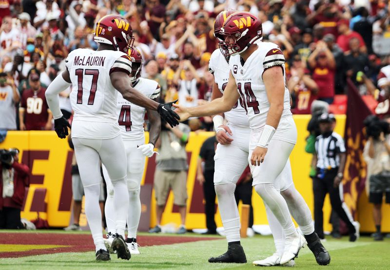 Washington Commanders quarterback Sam Howell (14) celebrates during an NFL football game against the Arizona Cardinals, Sunday, September 10, 2023 in Landover, Maryland. (AP Photo/Daniel Kucin Jr.)