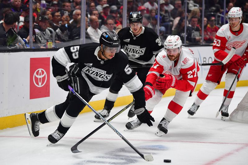 Oct 30, 2025; Los Angeles, California, USA; Los Angeles Kings right wing Quinton Byfield (55) moves the puck ahead of Detroit Red Wings center Michael Rasmussen (27) during the second period at Crypto.com Arena. Mandatory Credit: Gary A. Vasquez-Imagn Images
