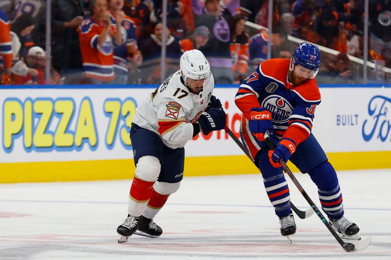 Jun 15, 2024; Edmonton, Alberta, CAN; Edmonton Oilers left wing Warren Foegele (37) skates with the puck defended by Florida Panthers center Evan Rodrigues (17) in the first period in game four of the 2024 Stanley Cup Final at Rogers Place. Mandatory Credit: Perry Nelson-USA TODAY Sports
