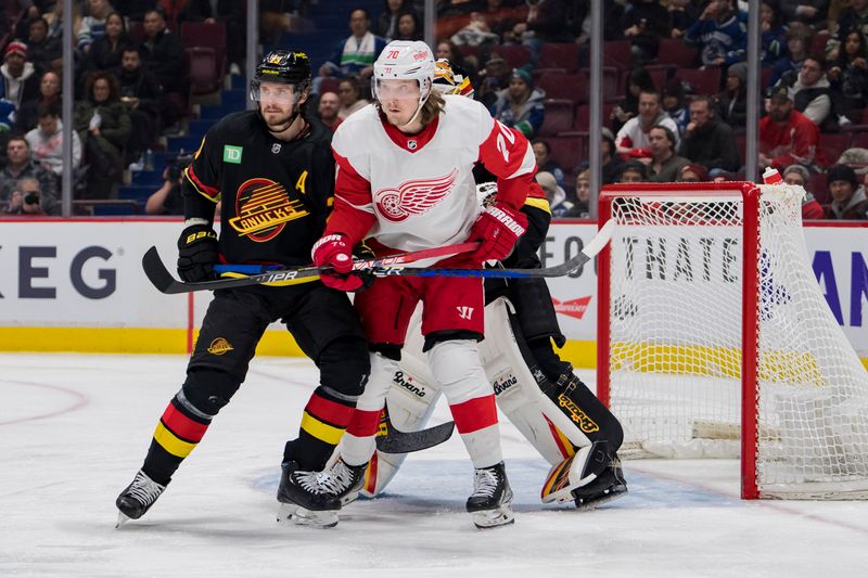 Feb 13, 2023; Vancouver, British Columbia, CAN; Vancouver Canucks defenseman Oliver Ekman-Larsson (23) battles with Detroit Red Wings forward Oskar Sundqvist (70) in the second period at Rogers Arena. Mandatory Credit: Bob Frid-USA TODAY Sports