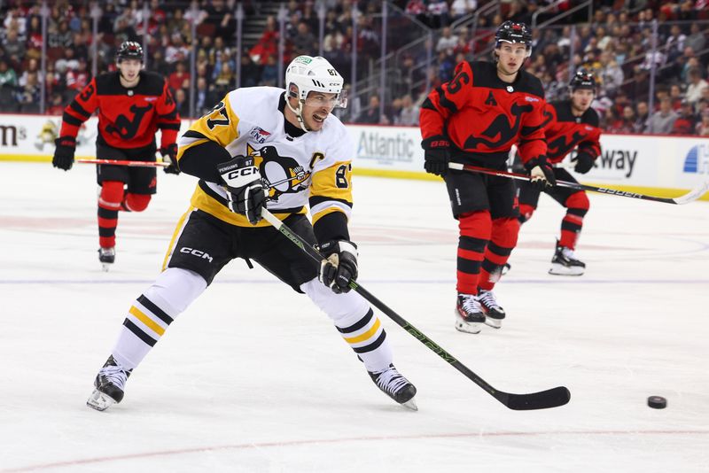 Mar 19, 2024; Newark, New Jersey, USA; Pittsburgh Penguins center Sidney Crosby (87) passes the puck against the New Jersey Devils during the first period at Prudential Center. Mandatory Credit: Ed Mulholland-USA TODAY Sports