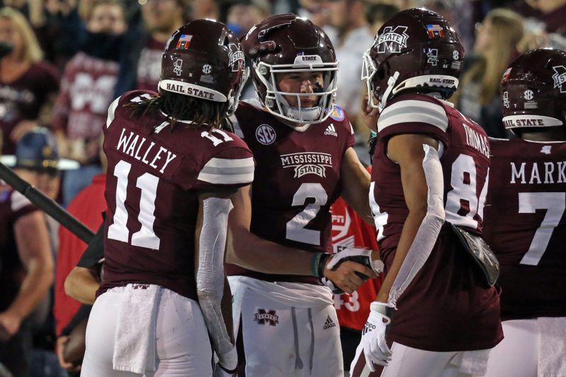 Dec 28, 2021; Memphis, TN, USA; Mississippi State Bulldogs quarterback Will Rogers (2) reacts with wide receiver Jaden Walley (11) and wide receiver Rara Thomas (84) after a touchdown during the first half against the Texas Tech Red Raiders at Liberty Bowl Stadium. Mandatory Credit: Petre Thomas-USA TODAY Sports