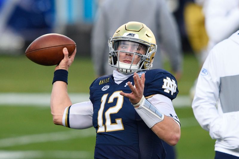 Dec 19, 2020; Charlotte, NC, USA; Notre Dame Fighting Irish quarterback Ian Book (12) warms up before the game at Bank of America Stadium. Mandatory Credit: Bob Donnan-USA TODAY Sports