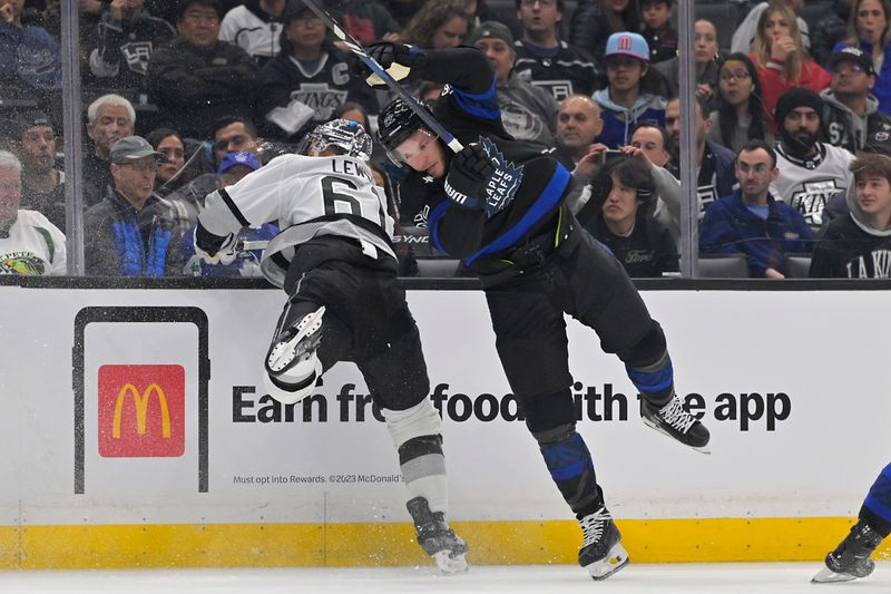 Jan 2, 2024; Los Angeles, California, USA; Los Angeles Kings center Trevor Lewis (61) and Toronto Maple Leafs defenseman Jake McCabe (22) clash along the boards in the first period at Crypto.com Arena. Mandatory Credit: Jayne Kamin-Oncea-USA TODAY Sports