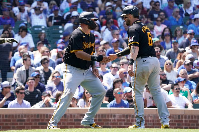 May 17, 2024; Chicago, Illinois, USA; Pittsburgh Pirates catcher Yasmani Grandal (6) greets Pittsburgh Pirates first base Rowdy Tellez (44) after scoring against the Chicago Cubs during the fourth inning at Wrigley Field. Mandatory Credit: David Banks-USA TODAY Sports