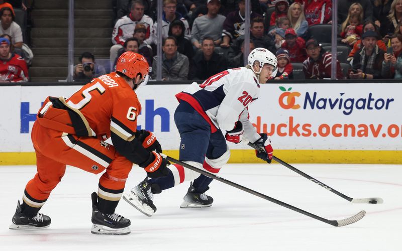 Mar 11, 2025; Anaheim, California, USA; Washington Capitals center Lars Eller (20) shoots against Anaheim Ducks defenseman Jacob Trouba (65) during the first period at Honda Center. Mandatory Credit: Jason Parkhurst-Imagn Images