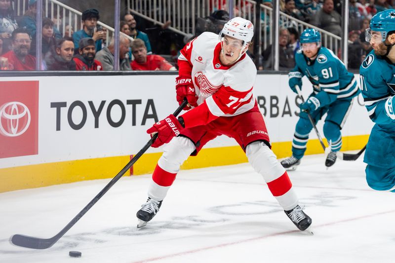 Nov 18, 2024; San Jose, California, USA; Detroit Red Wings defenseman Simon Edvinsson (77) skates for the puck during the second period against the San Jose Sharks at SAP Center at San Jose. Mandatory Credit: Bob Kupbens-Imagn Images