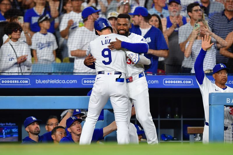 Aug 19, 2024; Los Angeles, California, USA; Los Angeles Dodgers second baseman Gavin Lux (9) is greeted by left fielder Teoscar Hernandez (37) after hitting a solo home run against the Seattle Mariners during the seventh inning at Dodger Stadium. Mandatory Credit: Gary A. Vasquez-USA TODAY Sports