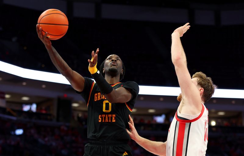 Dec 23, 2025; Columbus, Ohio, USA; Grambling State Tigers guard Derrius Ward (0) shoots the ball as Ohio State Buckeyes forward Brandon Noel (14) defends during the first half at Value City Arena. Mandatory Credit: Joseph Maiorana-Imagn Images