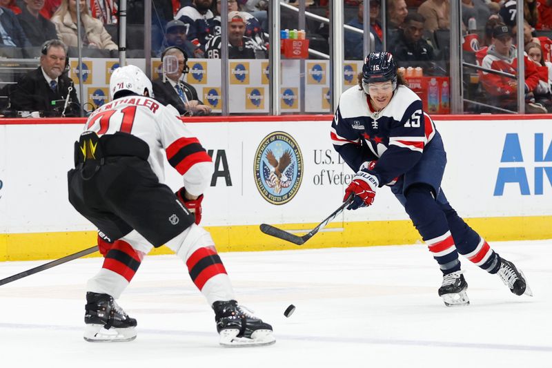 Feb 20, 2024; Washington, District of Columbia, USA; Washington Capitals left wing Sonny Milano (15) skates with the puck as New Jersey Devils defenseman Jonas Siegenthaler (71) defends in the second period at Capital One Arena. Mandatory Credit: Geoff Burke-USA TODAY Sports