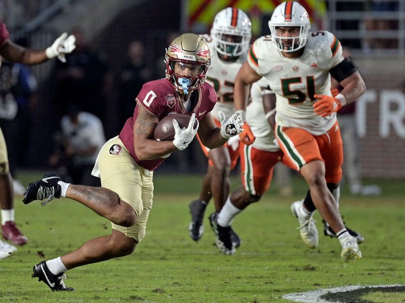 Nov 11, 2023; Tallahassee, Florida, USA; Florida State Seminoles wide receiver Ja'Khi Douglas (0) runs the ball against the Miami Hurricanes in the second half at Doak S. Campbell Stadium. Mandatory Credit: Melina Myers-USA TODAY Sports