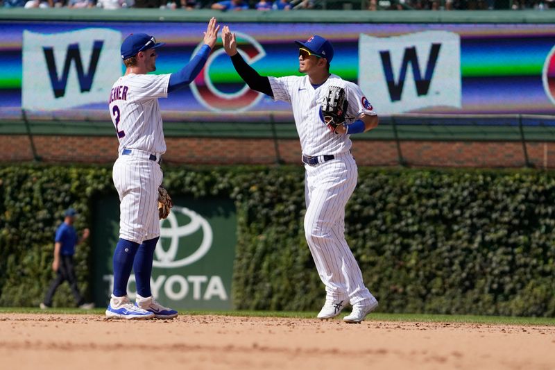 Sep 4, 2023; Chicago, Illinois, USA; Chicago Cubs right fielder Seiya Suzuki (27) and second baseman Nico Hoerner (2) celebrate their win against the San Francisco Giants at Wrigley Field. Mandatory Credit: David Banks-USA TODAY Sports