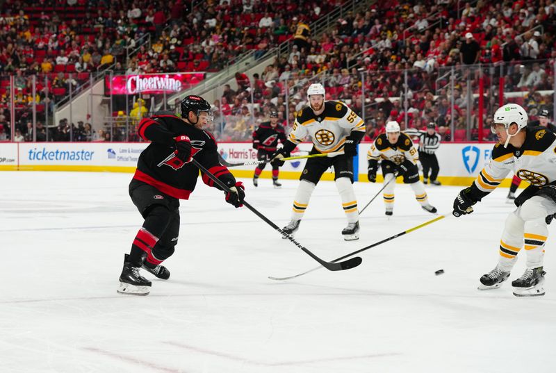 Oct 31, 2024; Raleigh, North Carolina, USA;  Carolina Hurricanes center Jesperi Kotkaniemi (82) scores a goal on his shot against the Boston Bruins during the third period at Lenovo Center. Mandatory Credit: James Guillory-Imagn Images