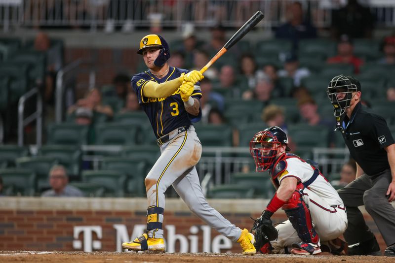 Aug 7, 2024; Atlanta, Georgia, USA; Milwaukee Brewers third baseman Joey Ortiz (3) hits a RBI double against the Atlanta Braves in the eighth inning at Truist Park. Mandatory Credit: Brett Davis-USA TODAY Sports