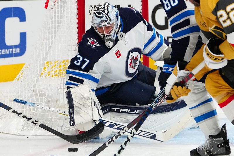 Nov 2, 2023; Las Vegas, Nevada, USA; Winnipeg Jets goaltender Connor Hellebuyck (37) looks to make a save against the Vegas Golden Knights during the third period at T-Mobile Arena. Mandatory Credit: Stephen R. Sylvanie-USA TODAY Sports