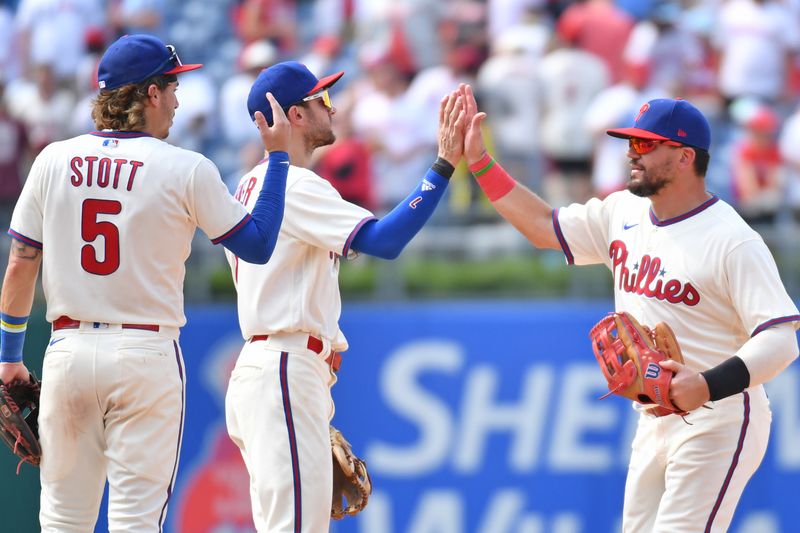 Aug 6, 2023; Philadelphia, Pennsylvania, USA; Philadelphia Phillies left fielder Kyle Schwarber (12) high fives shortstop Trea Turner (7) and second baseman Bryson Stott (5) as the celebrate win against the Kansas City Royals at Citizens Bank Park. Mandatory Credit: Eric Hartline-USA TODAY Sports