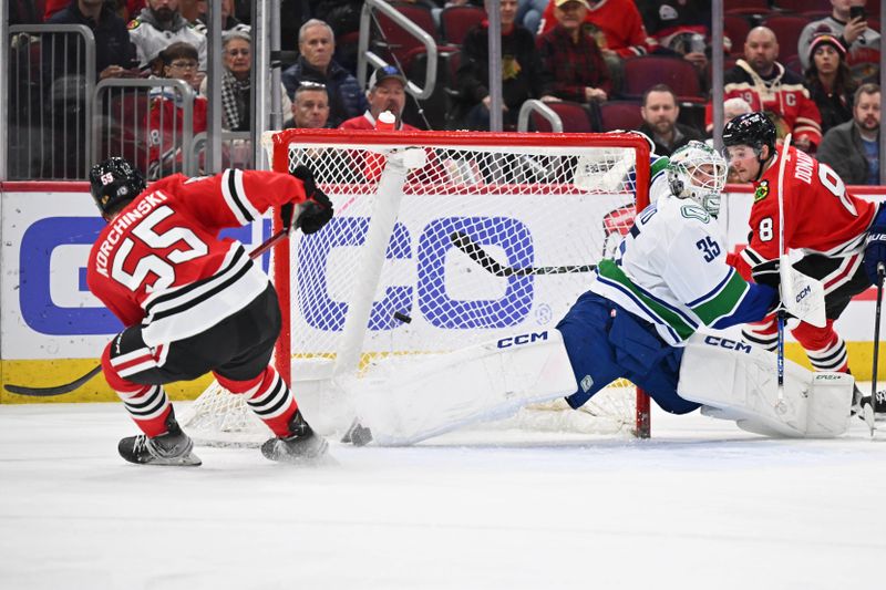 Feb 13, 2024; Chicago, Illinois, USA; Vancouver Canucks goaltender Thatcher Demko (35) is scored on by Chicago Blackhawks defenseman Kevin Korchinski (55) in the third period at United Center. Mandatory Credit: Jamie Sabau-USA TODAY Sports