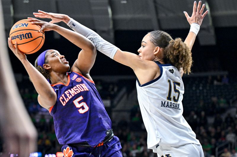 Feb 22, 2024; South Bend, Indiana, USA; Clemson Tigers forward Amari Robinson (5) goes up for a shot as Notre Dame Fighting Irish forward Nat Marshall (15) defends in the first half at the Purcell Pavilion. Mandatory Credit: Matt Cashore-USA TODAY Sports