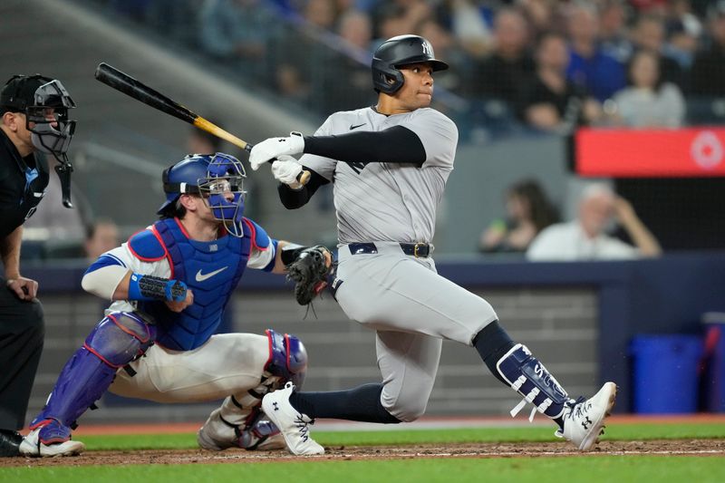 Apr 16, 2024; Toronto, Ontario, CAN; New York Yankees right fielder Juan Soto (22) hits a single against the Toronto Blue Jays during the sixth inning at Rogers Centre. Mandatory Credit: John E. Sokolowski-USA TODAY Sports