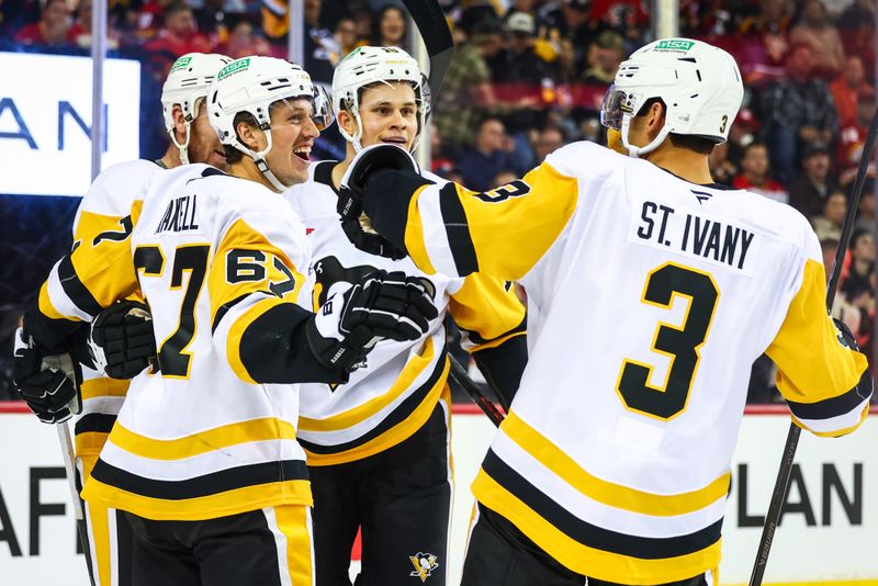 Oct 22, 2024; Calgary, Alberta, CAN; Pittsburgh Penguins right wing Rickard Rakell (67) celebrates his goal with teammates against the Calgary Flames during the third period at Scotiabank Saddledome. Mandatory Credit: Sergei Belski-Imagn Images