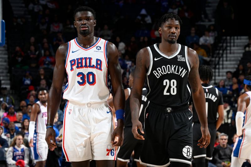 PHILADELPHIA, PA - OCTOBER 16: Adem Bona #30 of the Philadelphia 76ers and Dorian Finney-Smith #28 of the Brooklyn Nets looks on during the 76ers game on October 16, 2024 at the Wells Fargo Center in Philadelphia, Pennsylvania NOTE TO USER: User expressly acknowledges and agrees that, by downloading and/or using this Photograph, user is consenting to the terms and conditions of the Getty Images License Agreement. Mandatory Copyright Notice: Copyright 2024 NBAE (Photo by David Dow/NBAE via Getty Images)