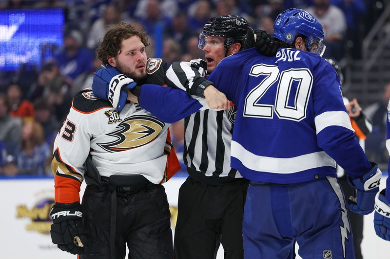 Jan 13, 2024; Tampa, Florida, USA;  Anaheim Ducks center Mason McTavish (23) goes after Tampa Bay Lightning left wing Nicholas Paul (20) in the third period at Amalie Arena. Mandatory Credit: Nathan Ray Seebeck-USA TODAY Sports