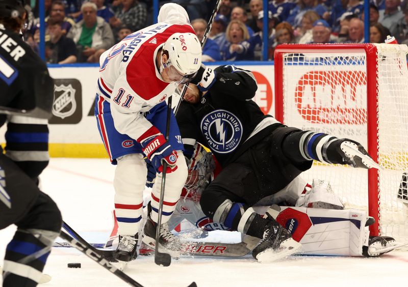 Mar 2, 2024; Tampa, Florida, USA;  Montreal Canadiens right wing Brendan Gallagher (11) and goaltender Cayden Primeau (30) defends Tampa Bay Lightning center Anthony Cirelli (71) during the first period at Amalie Arena. Mandatory Credit: Kim Klement Neitzel-USA TODAY Sports