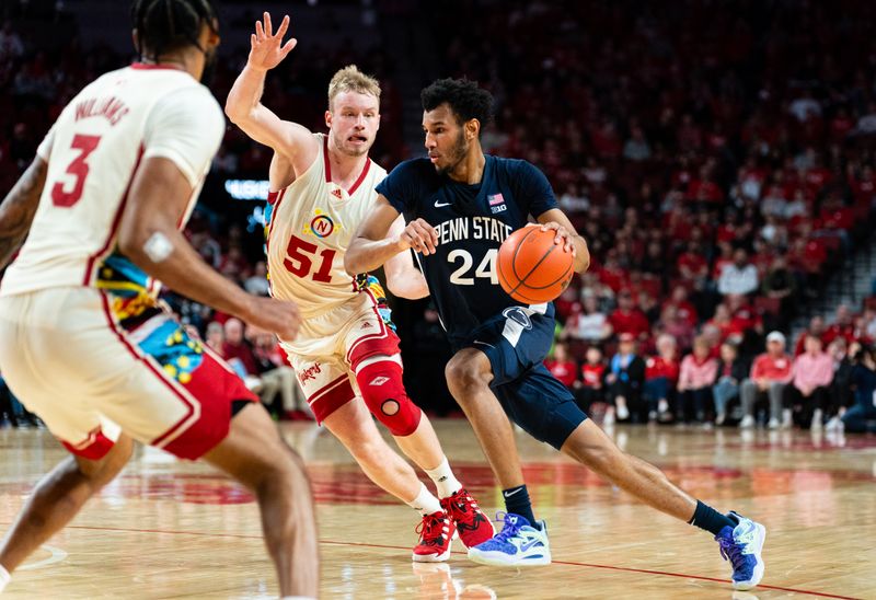 Feb 17, 2024; Lincoln, Nebraska, USA; Penn State Nittany Lions forward Zach Hicks (24) drives against Nebraska Cornhuskers forward Rienk Mast (51) and guard Brice Williams (3) during the second half at Pinnacle Bank Arena. Mandatory Credit: Dylan Widger-USA TODAY Sports