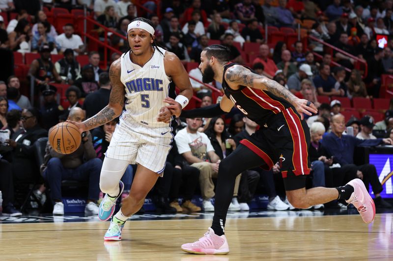 MIAMI, FLORIDA - FEBRUARY 06: Paolo Banchero #5 of the Orlando Magic drives against Caleb Martin #16 of the Miami Heat during the first quarter of the game at Kaseya Center on February 06, 2024 in Miami, Florida. NOTE TO USER: User expressly acknowledges and agrees that, by downloading and or using this photograph, User is consenting to the terms and conditions of the Getty Images License Agreement. (Photo by Megan Briggs/Getty Images)