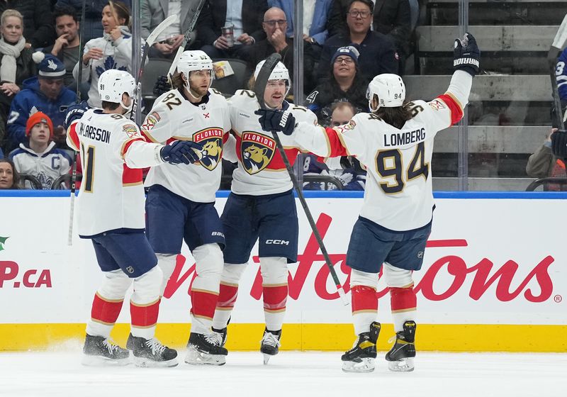 Nov 28, 2023; Toronto, Ontario, CAN; Florida Panthers center Kevin Stenlund (82) scores a goal and celebrates with Florida Panthers left wing Ryan Lomberg (94) against the Toronto Maple Leafs during the first period at Scotiabank Arena. Mandatory Credit: Nick Turchiaro-USA TODAY Sports