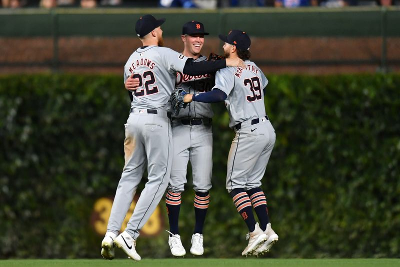 Aug 21, 2024; Chicago, Illinois, USA; Detroit Tigers center fielder Parker Meadows (left), right fielder Kerry Carpenter (center), and left fielder Zach McKinstry (right) celebrate after defeating the Chicago Cubs at Wrigley Field. Mandatory Credit: Patrick Gorski-USA TODAY Sports