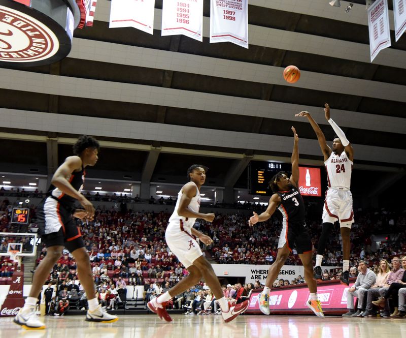 Feb 18, 2023; Tuscaloosa, Alabama, USA; Alabama forward Brandon Miller (24) drains a three point shot over Georgia guard Kario Oquendo (3) at Coleman Coliseum. Mandatory Credit: Gary Cosby Jr.-USA TODAY Sports