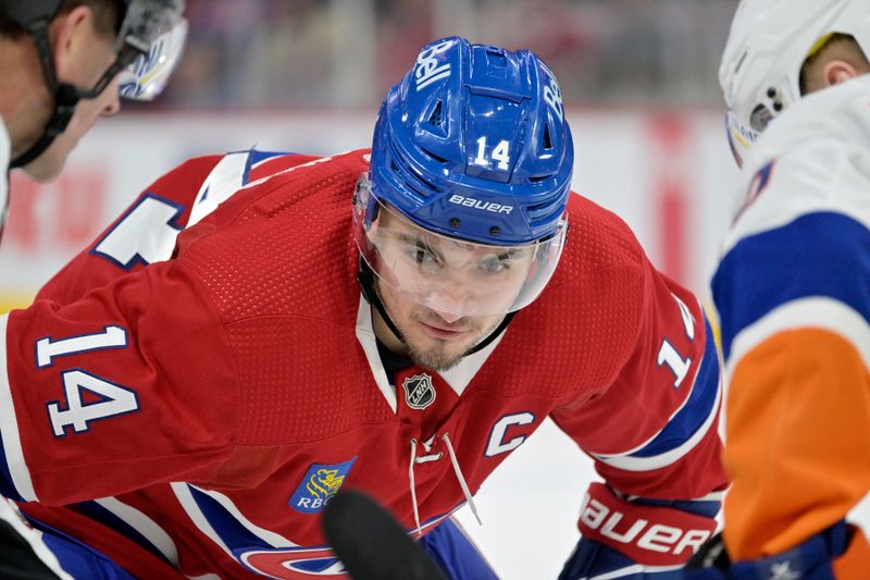 Jan 25, 2024; Montreal, Quebec, CAN; Montreal Canadiens forward Nick Suzuki (14) prepares for a face off  against the New York Islanders during the first period at the Bell Centre. Mandatory Credit: Eric Bolte-USA TODAY Sports