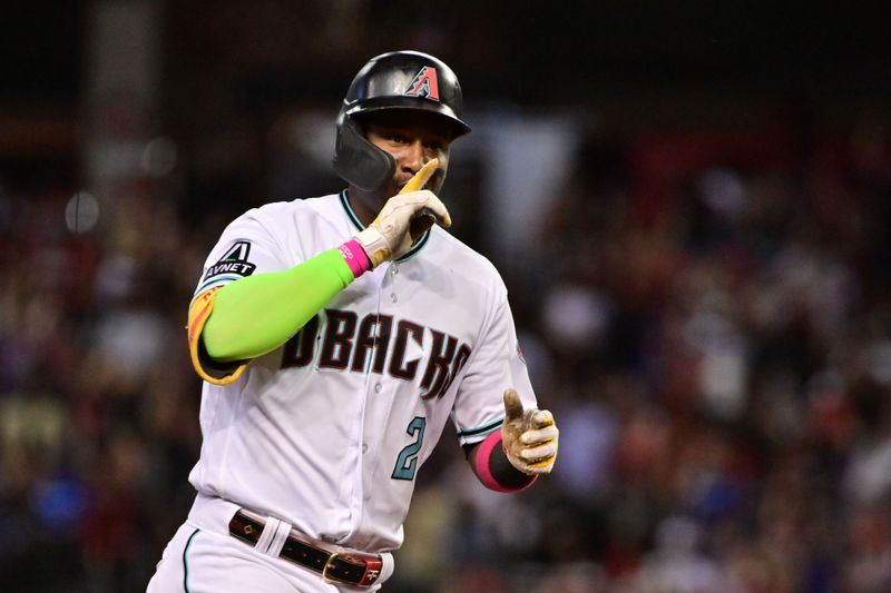 Oct 11, 2023; Phoenix, Arizona, USA; Arizona Diamondbacks shortstop Geraldo Perdomo (2) reacts after hitting a home run against the Los Angeles Dodgers in the third inning for game three of the NLDS for the 2023 MLB playoffs at Chase Field. Mandatory Credit: Matt Kartozian-USA TODAY Sports