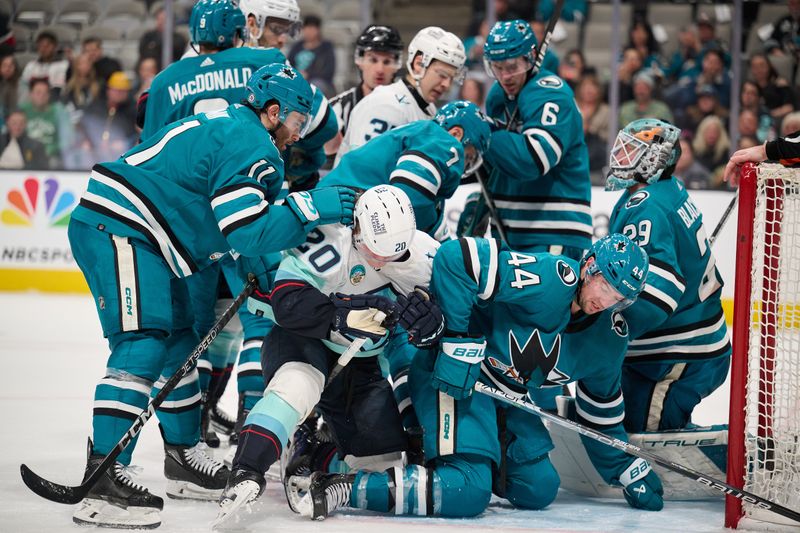 Jan 30, 2024; San Jose, California, USA; Seattle Kraken right wing Eeli Tolvanen (20) vies for a loose puck in the goal crease against the San Jose Sharks during the third period at SAP Center at San Jose. Mandatory Credit: Robert Edwards-USA TODAY Sports