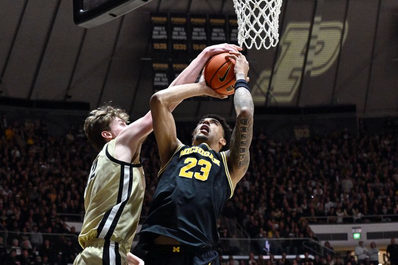 Feb 17, 2026; West Lafayette, Indiana, USA; Purdue Boilermakers center Daniel Jacobsen (12) blocks a shot by Michigan Wolverines forward Yaxel Lendeborg (23) during the first half at Mackey Arena. Mandatory Credit: Marc Lebryk-Imagn Images