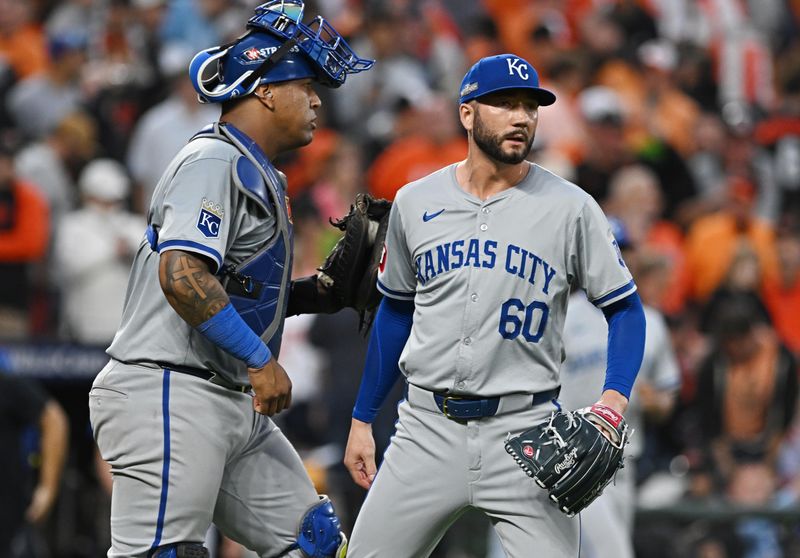 Oct 1, 2024; Baltimore, Maryland, USA; Kansas City Royals pitcher Lucas Erceg (60) and Kansas City Royals catcher Salvador Perez (13) celebrate after defeating the Baltimore Orioles in game one of the Wild Card round for the 2024 MLB Playoffs at Oriole Park at Camden Yards. Mandatory Credit: Tommy Gilligan-Imagn Images