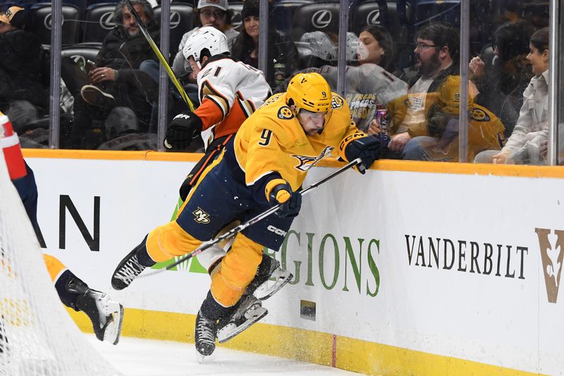 Jan 9, 2024; Nashville, Tennessee, USA; Nashville Predators left wing Filip Forsberg (9) hits Anaheim Ducks center Isac Lundestrom (21) during the third period at Bridgestone Arena. Mandatory Credit: Christopher Hanewinckel-USA TODAY Sports