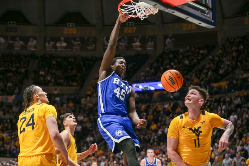 Feb 3, 2024; Morgantown, West Virginia, USA; Brigham Young Cougars forward Fousseyni Traore (45) dunks the ball during the first half against the West Virginia Mountaineers at WVU Coliseum. Mandatory Credit: Ben Queen-USA TODAY Sports