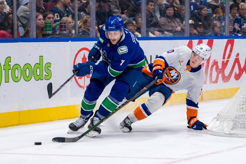 Nov 14, 2024; Vancouver, British Columbia, CAN; New York Islanders forward Simon Holmstrom (10) stick checks Vancouver Canucks defenseman Carson Soucy (7) during the second period at Rogers Arena. Mandatory Credit: Bob Frid-Imagn Images