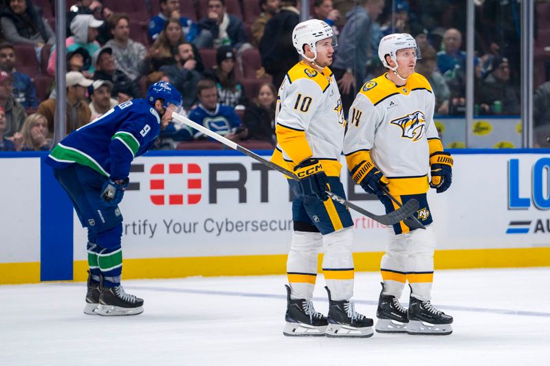 Jan 3, 2025; Vancouver, British Columbia, CAN; Vancouver Canucks forward J.T. Miller (9) watches as Nashville Predators forward Colton Sissons (10) and forward Gustav Nyquist (14) celebrate Nyquist’s goal  in the third period at Rogers Arena. Mandatory Credit: Bob Frid-Imagn Images