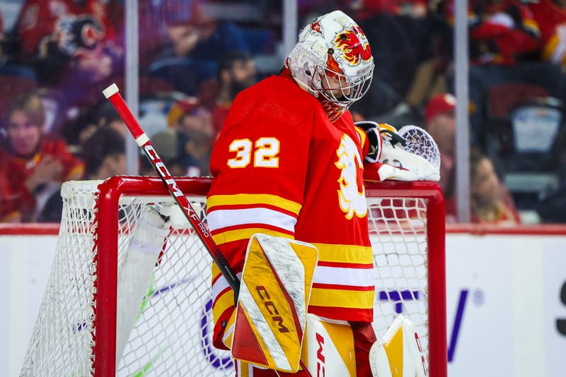 Apr 18, 2024; Calgary, Alberta, CAN; Calgary Flames goaltender Dustin Wolf (32) reacts to the goal by San Jose Sharks left wing Fabian Zetterlund (not pictured) during the third period at Scotiabank Saddledome. Mandatory Credit: Sergei Belski-USA TODAY Sports