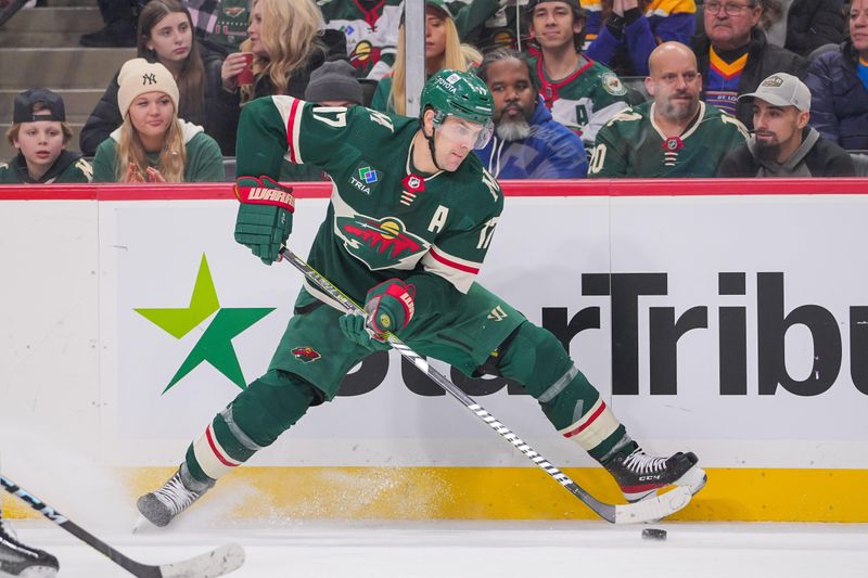 Nov 28, 2023; Saint Paul, Minnesota, USA; Minnesota Wild left wing Marcus Foligno (17) skates with the puck against the St. Louis Blues in the second period at Xcel Energy Center. Mandatory Credit: Brad Rempel-USA TODAY Sports