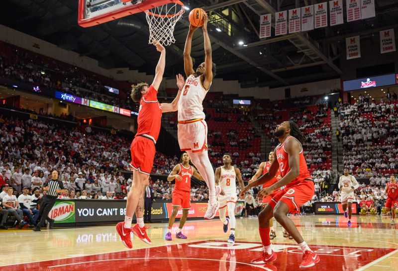 Dec 4, 2024; College Park, Maryland, USA; Maryland Terrapins forward Tafara Gapare (6) dunks the ball over Ohio State Buckeyes center Austin Parks (25) during the second half at Xfinity Center. Mandatory Credit: Reggie Hildred-Imagn Images