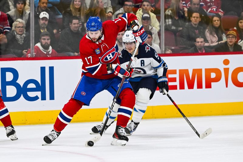 Oct 28, 2023; Montreal, Quebec, CAN; Montreal Canadiens right wing Josh Anderson (17) plays the puck against Winnipeg Jets center Mark Scheifele (55) during the third period at Bell Centre. Mandatory Credit: David Kirouac-USA TODAY Sports