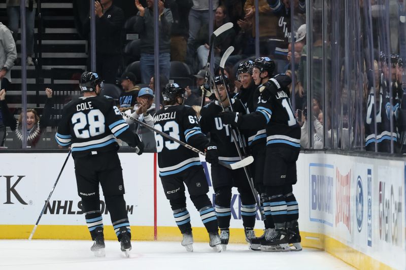 Nov 13, 2024; Salt Lake City, Utah, USA; The Utah Hockey Club celebrates a goal by center Nick Bjugstad (17) against the Carolina Hurricanes during the first period at Delta Center. Mandatory Credit: Rob Gray-Imagn Images