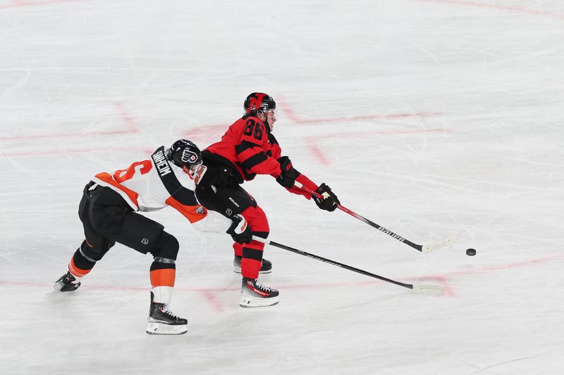 Feb 17, 2024; East Rutherford, New Jersey, USA; New Jersey Devils center Jack Hughes (86) skates with the puck on a break away as Philadelphia Flyers defenseman Travis Sanheim (6) defends during the third period in a Stadium Series ice hockey game at MetLife Stadium. Mandatory Credit: Vincent Carchietta-USA TODAY Sports