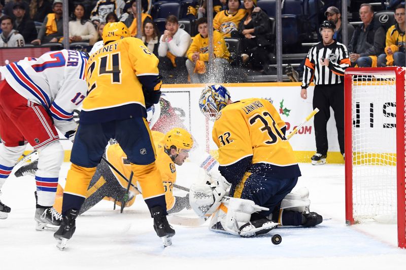 Dec 2, 2023; Nashville, Tennessee, USA; Nashville Predators goaltender Kevin Lankinen (32) has the puck go wide of the net after a save against the New York Rangers during the second period at Bridgestone Arena. Mandatory Credit: Christopher Hanewinckel-USA TODAY Sports