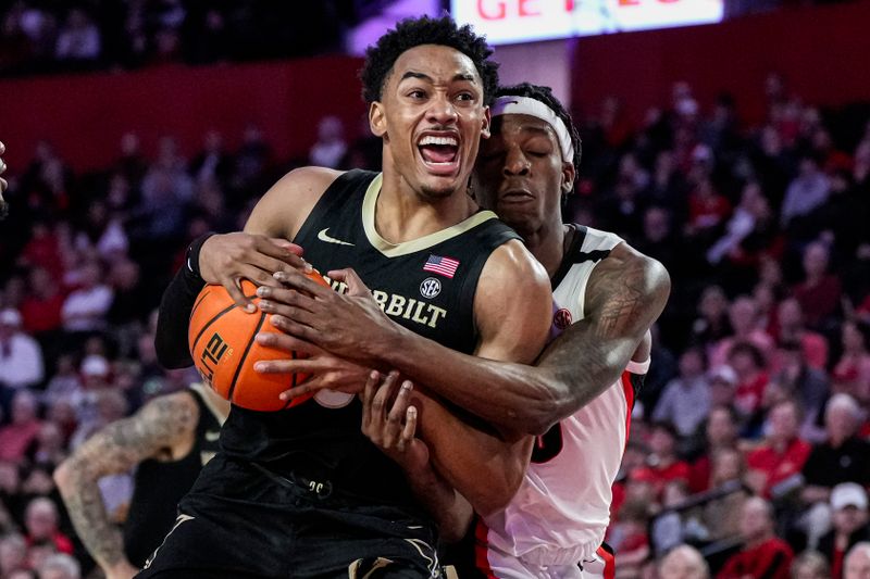 Jan 21, 2023; Athens, Georgia, USA; Vanderbilt Commodores guard Tyrin Lawrence (0) tries to get to the basket defended by Georgia Bulldogs guard Terry Roberts (0) during the first half at Stegeman Coliseum. Mandatory Credit: Dale Zanine-USA TODAY Sports