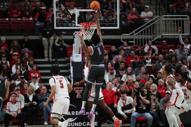 Jan 13, 2024; Lubbock, Texas, USA;  Kansas State Wildcats wing David N Guessan (1) shoots over Texas Tech Red Raiders forward Warren Washington (22) in the first half at United Supermarkets Arena. Mandatory Credit: Michael C. Johnson-USA TODAY Sports